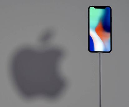 (FILES) This file photo taken on September 12, 2017 shows an iPhone X during a media event at Apple's new headquarters in Cupertino, California. Apple announced on January 17, 2018, it would pay about $38 billion in taxes -- likely the largest payment of its kind -- on profits repatriated from overseas as it boosts investments in the United States. / AFP PHOTO / Josh Edelson