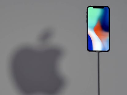 (FILES) This file photo taken on September 12, 2017 shows an iPhone X during a media event at Apple's new headquarters in Cupertino, California.  Apple announced on January 17, 2018, it would pay about $38 billion in taxes -- likely the largest payment of its kind -- on profits repatriated from overseas as it boosts investments in the United States. / AFP PHOTO / Josh Edelson