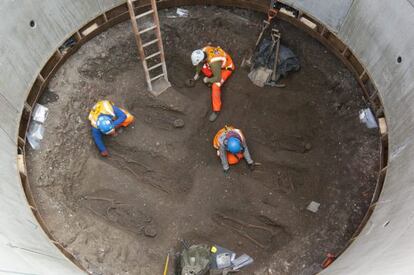 Imagen sin fechar distribuida por Crossrails hoy viernes 15 de marzo de 2013, que muestra a un grupo de arqueólogos mientras trabajan con un esqueleto encontrado durante la excavación de un túnel ferroviario en Farringdon, Londres.