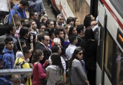 Numerosos pasajeros esperan para entrar en un tren, en la madrileña estación de Atocha. EFE/Archivo