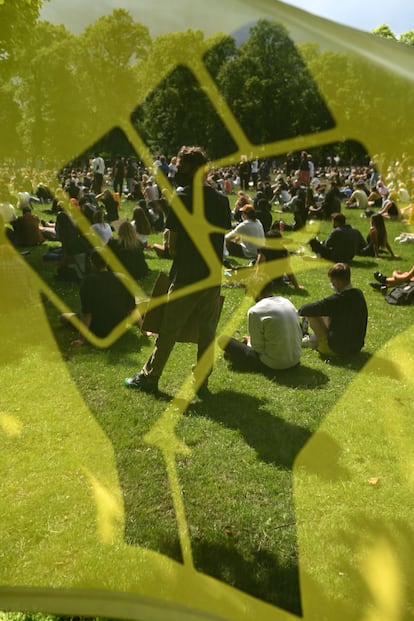 Manifestantes vistos a través de un puño en una bandera de Black Lives Matter, en Leeds, Inglaterra, el 21 de junio de 2020.