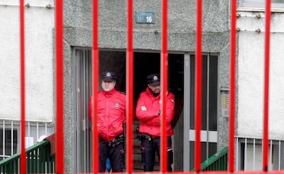 Agentes de la Ertzaintza cuestodian el portal de las v&iacute;ctimas.