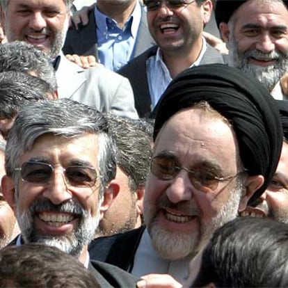 Mohamed Jatamí (derecha), ayer al abandonar el Parlamento iraní.