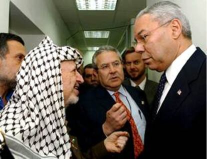 Arafat (izquierda) y Powell conversan en un pasillo de la residencia del líder palestino en Ramala.