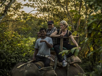 Veterinarian Deborah McCauley and Bishnu Lama on an elephant in Chitwan.