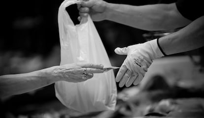 Un cliente paga la compra de pescado con billetes en el mercado de La Boquería en junio de 2011 en Barcelona. 