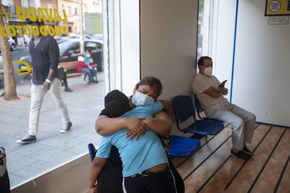 Karen y Andrei, abrazados mientras esperan a que termine de lavarse la ropa.