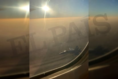 An image from inside the Air Canada plane of the F-18 fighter jet.