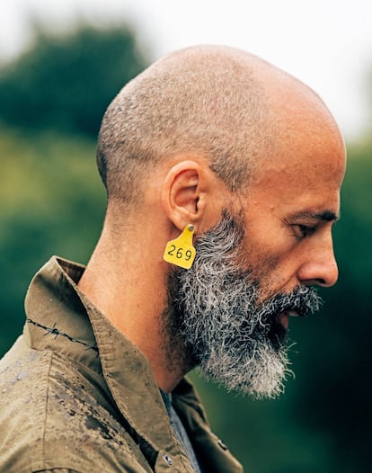 Juanjo Martínez, 47, a vegan activist, wears the symbol of the animal liberation movement, 269.