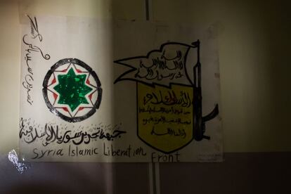 En una de las paredes del colegio los alumnos han colgado un dibujo con el emblema del Frente Islámico de Liberación de Siria, un conglomerado de varios grupos islamistas de corte moderado que lucha para derrocar el régimen del dictador sirio Bachar el Asad.