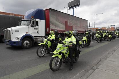 Integrantes de la policía antidisturbios llegan para dispersar bloqueos de transportadores, este jueves en Bogotá.