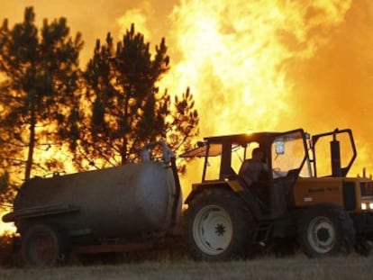 Un vecino de Vilamor (A Coru&ntilde;a) intenta combatir las llamas de un incendio.