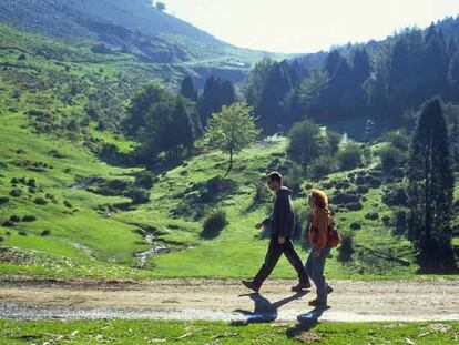Dos caminantes avanzan por el collado de Asuntza, muy cerca del monte Anboto, en el parque natural de Urkiola, en Vizcaya.