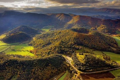 Hasta cuarenta cráteres y bocas de volcán asoman en el parque natural de Garrotxa. A pesar de ser un paisaje formado por la lava, el clima lluvioso ha propiciado que la vegetación cubra las onduladas lomas que se van escarpando y desnudando conforme se avanza hacia el norte. La lava, enfriada por los ríos, ha formado riscos de 40 metros de altura. Sobre uno de ellos se levantó el pueblo de Castellfollit de la Roca, donde las casas se dispusieron en la misma línea del precipicio. En el parque hay 11 municipios y el 98% del territorio es privado (es.turismegarrotxa.com).