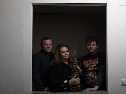 La familia que forman Juan, Eva e Iván sujeta un árbol de Navidad, uno de los enseres que pudieron sacar de su vivienda.