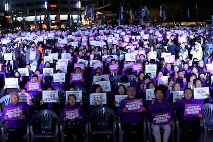 People hold the signs during a rally marking the first anniversary of the harrowing crowd surge that killed about 160 people in a Seoul alleyway, at the Seoul Plaza in Seoul, South Korea, Sunday, Oct. 29, 2023. The signs read "Find out the truth."