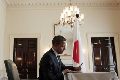 Barack Obama escribe un mensaje en el libro de firmas de la Embajada de Japón, ayer en Washington.