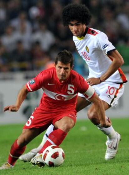 Emre se marcha del belga Fellaini durante un partido.