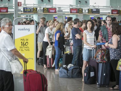 Passengers lining up at Vueling counters at Barcelona airport.