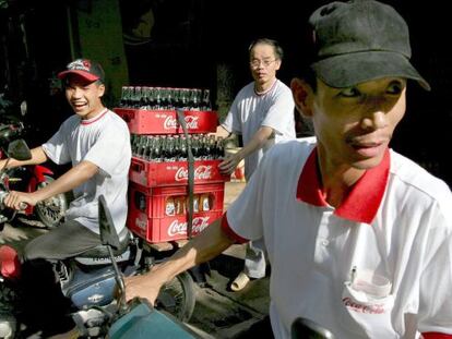 Distribuidores de Coca Cola cargan sus motos en Hanoi, Vietnam.