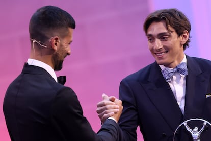 Mondo Duplantis recibe el premio Laureus al deportista del año de parte del ganador del año pasado, Novak Djokovic.