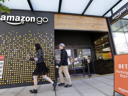 FILE - In this Thursday, April 27, 2017, file photo, people walk past an Amazon Go store in Seattle. More than a year after it introduced the concept, Amazon is opening its artificial intelligence-powered Amazon Go store in downtown Seattle on Monday, Jan. 22, 2018. (AP Photo/Elaine Thompson, File)