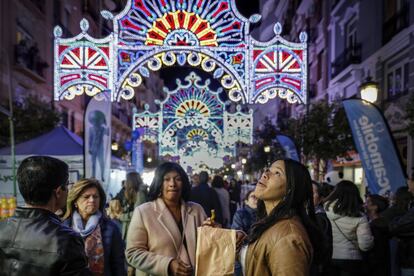 Tourists look at the ornamental lights that adorn the streets of Valencia during the fiestas.