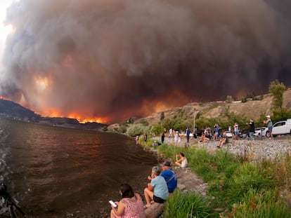 Residents stare at the McDougall Creek wildfire in West Kelowna, British Columbia, Canada, on August 17, 2023.