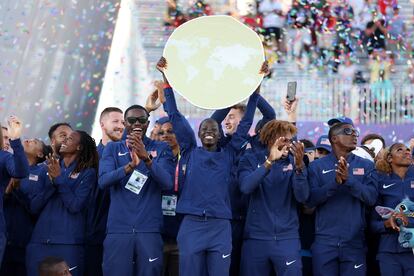 Athing Mu levanta el trofeo del mejor equipo del Mundial de Atletismo rodeada del resto de participantes estadounidenses.