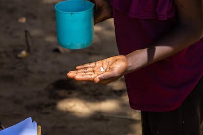 A person holds ivermectin pills.