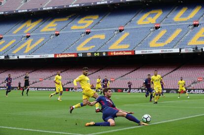 El jugador del Barcelona, Sergi Roberto, se desliza por el césped para evitar que el balón salga por la línea de fondo.