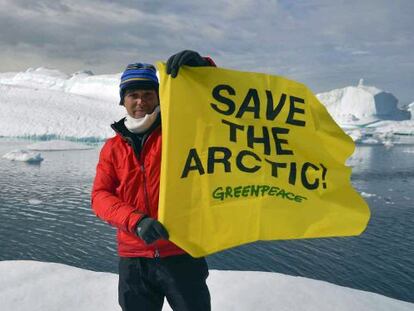 Alejandro the activist: Sanz holds aloft a Greenpeace flag during his eight-day Arctic trip.