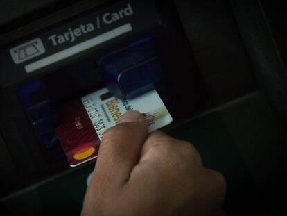 A person uses a credit card at a branch of Banco del Bienestar in March 2023.