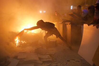 A demonstrator burns the Spanish flag at a protest in Barcelona.