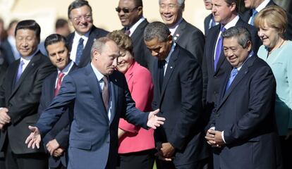 El presidente ruso Vladimir Putin, hace un gesto, tras llegar tarde a la foto de familia del grupo del G-20, 6 de septiembre de 2013.