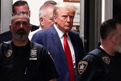 Former President Donald Trump is escorted to a courtroom, April 4, 2023