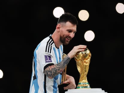Messi caresses the World Cup in Qatar after Argentina defeated France, on December 18, 2022.