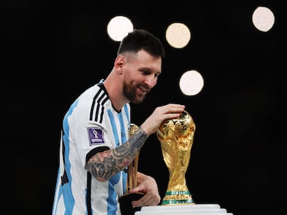 Messi caresses the World Cup in Qatar after Argentina defeated France, on December 18, 2022.