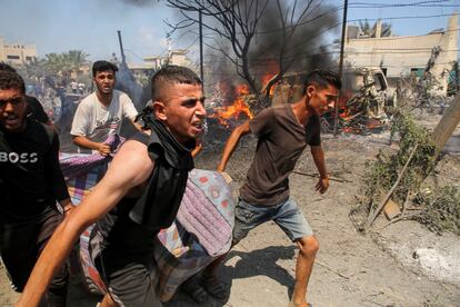 People carry a wounded person after an Israeli bombardment of Al Mawasi on Saturday. 