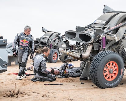 Carlos Sainz asiste a su compañero de equipo en Audi, Mattias Ekström, en la séptima etapa del Dakar.