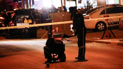 Forensic officers work at the site where Fernando Villavicencio was murdered, in Quito, in August 2023.