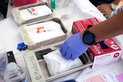 Syringes with vaccines are prepared at the L.A. Care and Blue Shield of California Promise Health Plans' Community Resource Center where they were offering members and the public free flu and COVID-19 vaccines Oct. 28, 2022, in Lynwood, Calif.