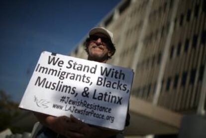 A man protests Trump's new immigration policies outside the ICE Federal Building in Los Angeles.