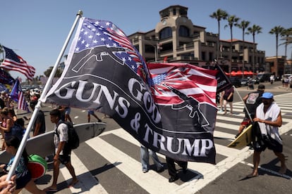 A pro-Trump supporter waves a flag reading God Guns and Trump during a demonstration in support of former U.S. President Donald Trump who was shot the previous day in an assassination attempt during a rally in Pennsylvania, in Huntington Beach, California, U.S. July 14, 2024.