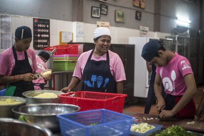 Nina (centro), cocinera de la ONG Friends International, en Phnom Penh, enseña a sus alumnos a manipular, preparar y servir los alimentos. Y cocinan pescado con arroz.
