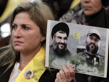 Una seguidora de Hezbol&aacute;, con una foto de Nasrala (izq.).