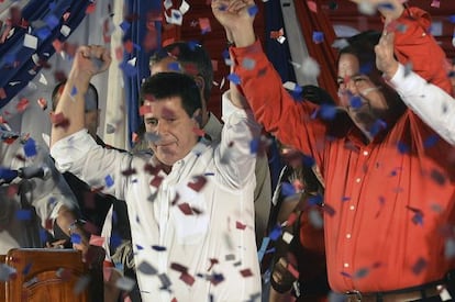 Paraguayan presidential candidate for the Colorado Party, Horacio Cartes (L) and his Vice-President Juan Afara, wave after winning the elections in Asunci&oacute;n.