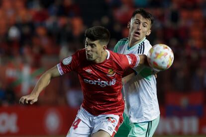 Quintanilla y Budimir pelean por un balón en el Nàstic-Osasuna.