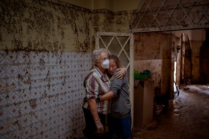 Vero Almarche, 36, right, hugs her neighbor Maria Munoz, 74, who was born in the house where they are photographed and which was destroyed by flooding in Masanasa, Valencia, Spain, Wednesday, Nov. 6, 2024. (AP Photo/Emilio Morenatti)