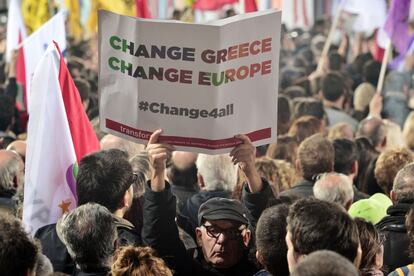 Seguidores de Syriza portan carteles con lemas por el cambio en Grecia y en Europa durante el discurso de cierre de campaña de Tsipras en el centro de Atenas.